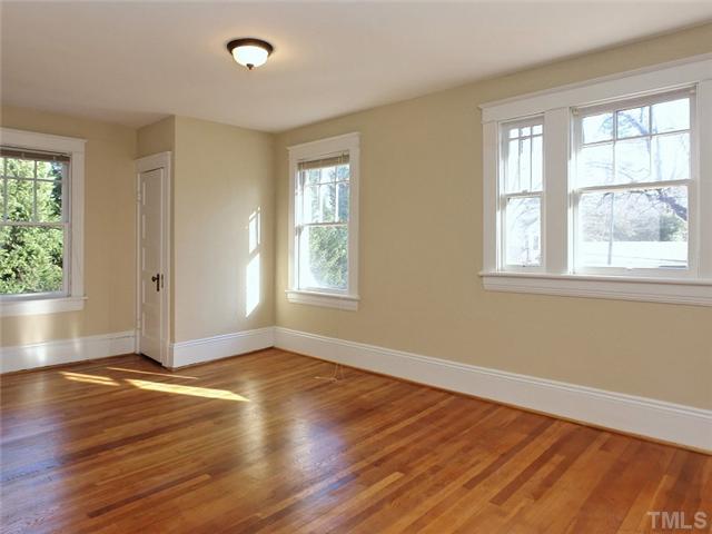 1413 Scales Street Raleigh, NC 27608 - Photo 19 of 24 an empty room with wooden floor and windows