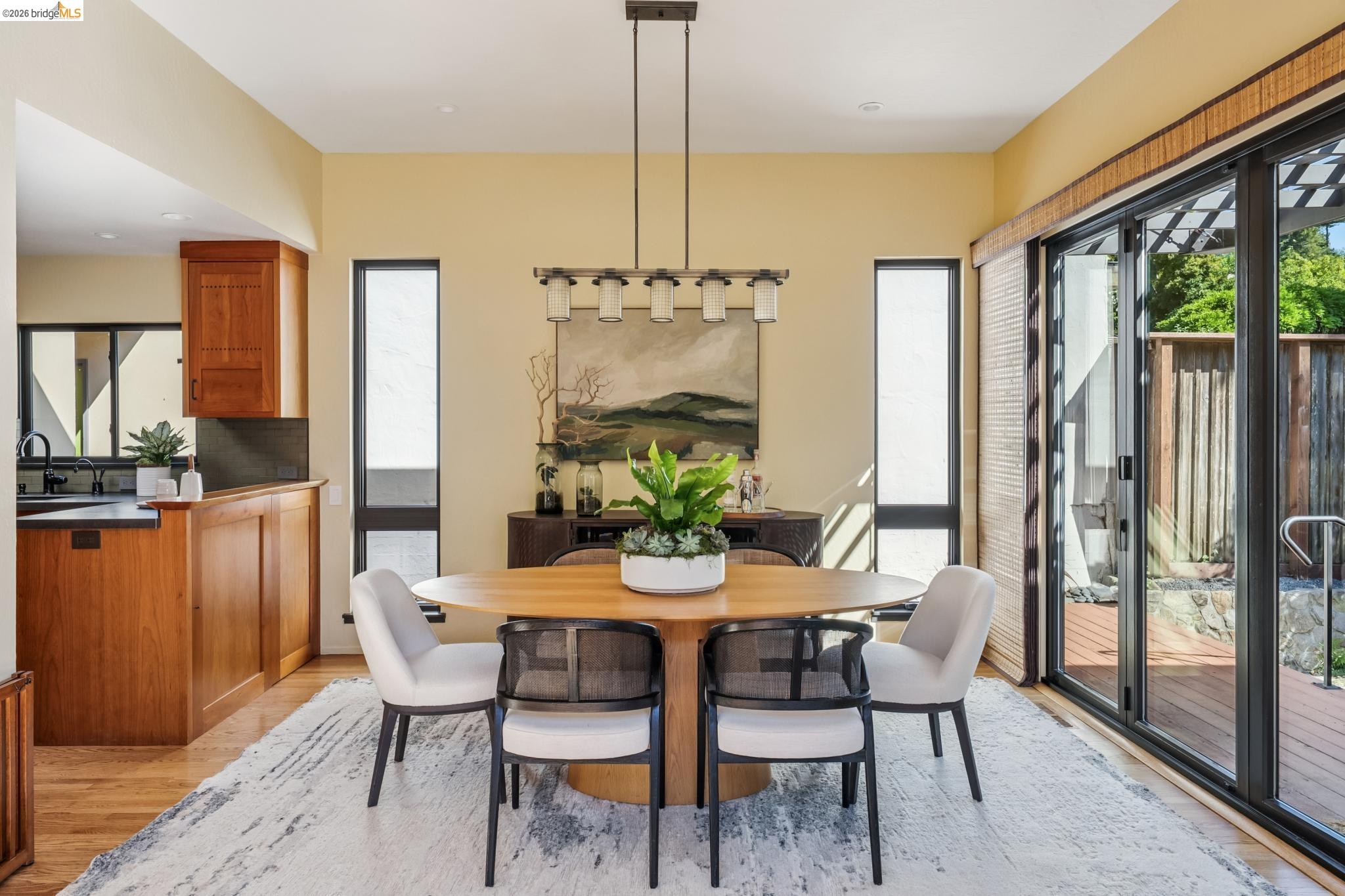576 Vistamont Avenue Berkeley, CA 94708 - Photo 13 of 33 Bright dining area featuring wood-finish flooring and a contemporary chandelier
