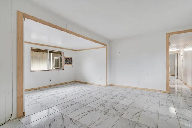 a view of an empty room with windows