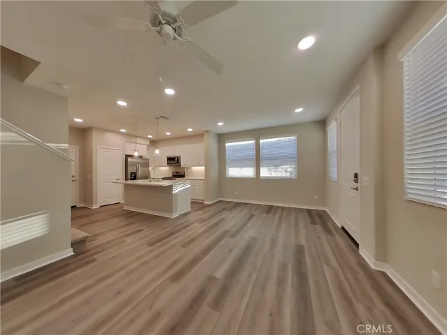 a view of empty room with wooden floor and window
