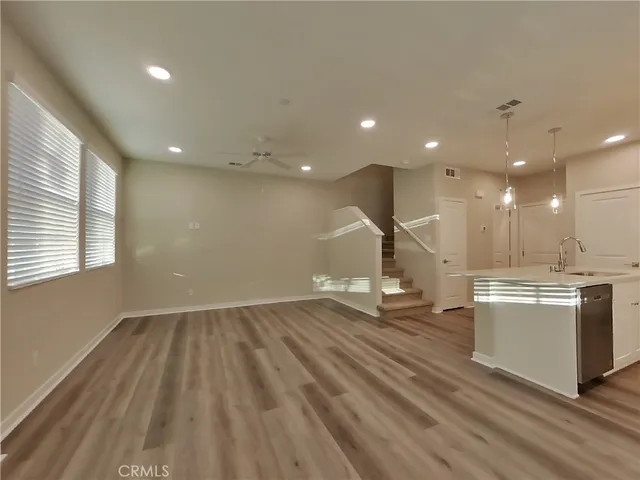 a kitchen with stainless steel appliances granite countertop a refrigerator and a stove