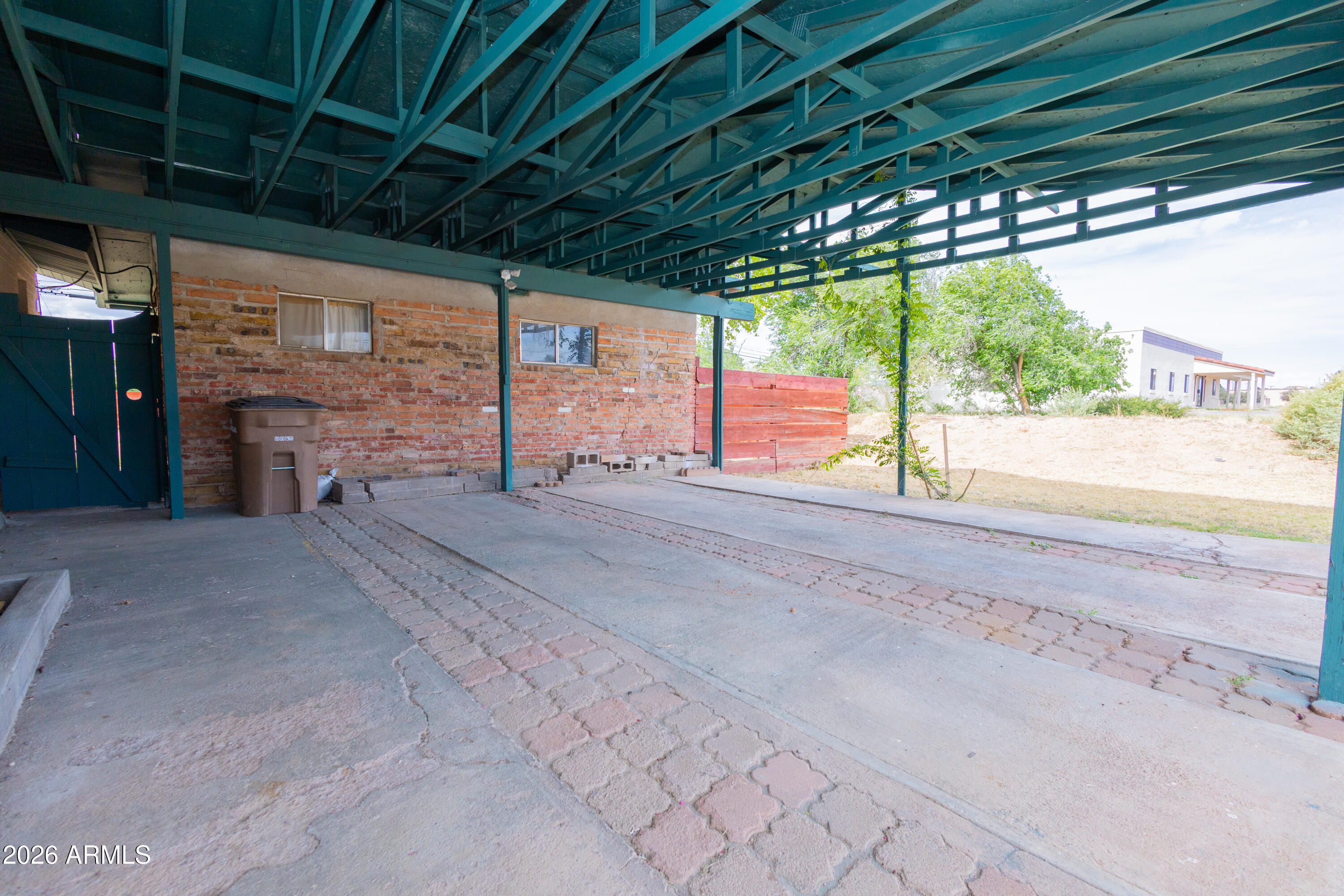 1626 11th Street Douglas, AZ 85607 - Photo 9 of 30 a view of porch with a table and chairs under a large umbrella
