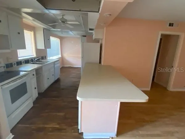 a kitchen with a sink stove and refrigerator
