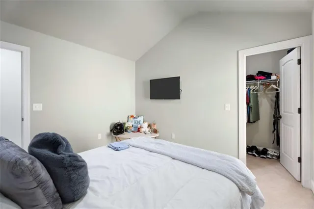 a bathroom with a granite countertop sink toilet and large mirror