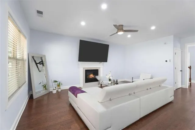 a living room with furniture a fireplace and a flat screen tv