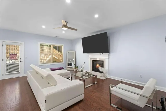 a living room with furniture a fireplace and a flat screen tv