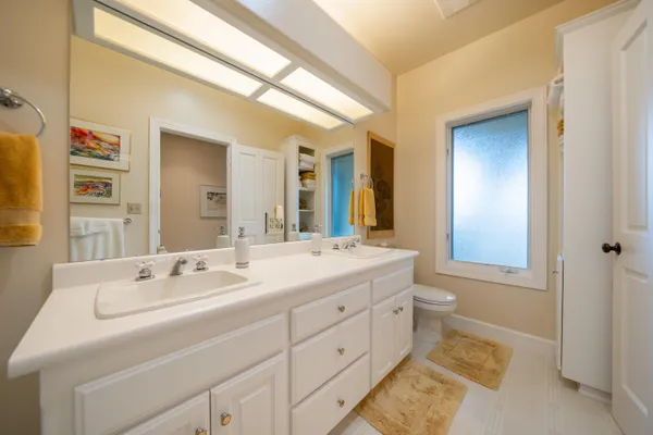 a spacious bathroom with a double vanity sink and a mirror