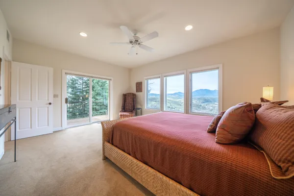 a bedroom with a large bed and a large window