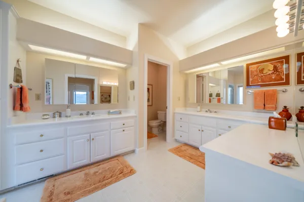 a spacious bathroom with a granite countertop sink mirror and bathtub