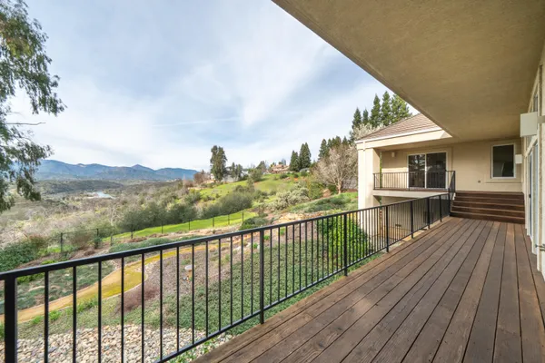 a view of a house with wooden deck
