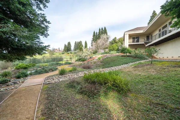a view of backyard of a house with green space