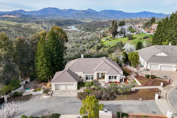 an aerial view of residential houses with outdoor space and street view