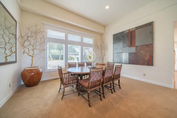 a dining room with furniture and window