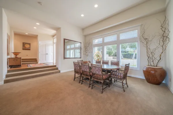 a dining room with furniture and windows