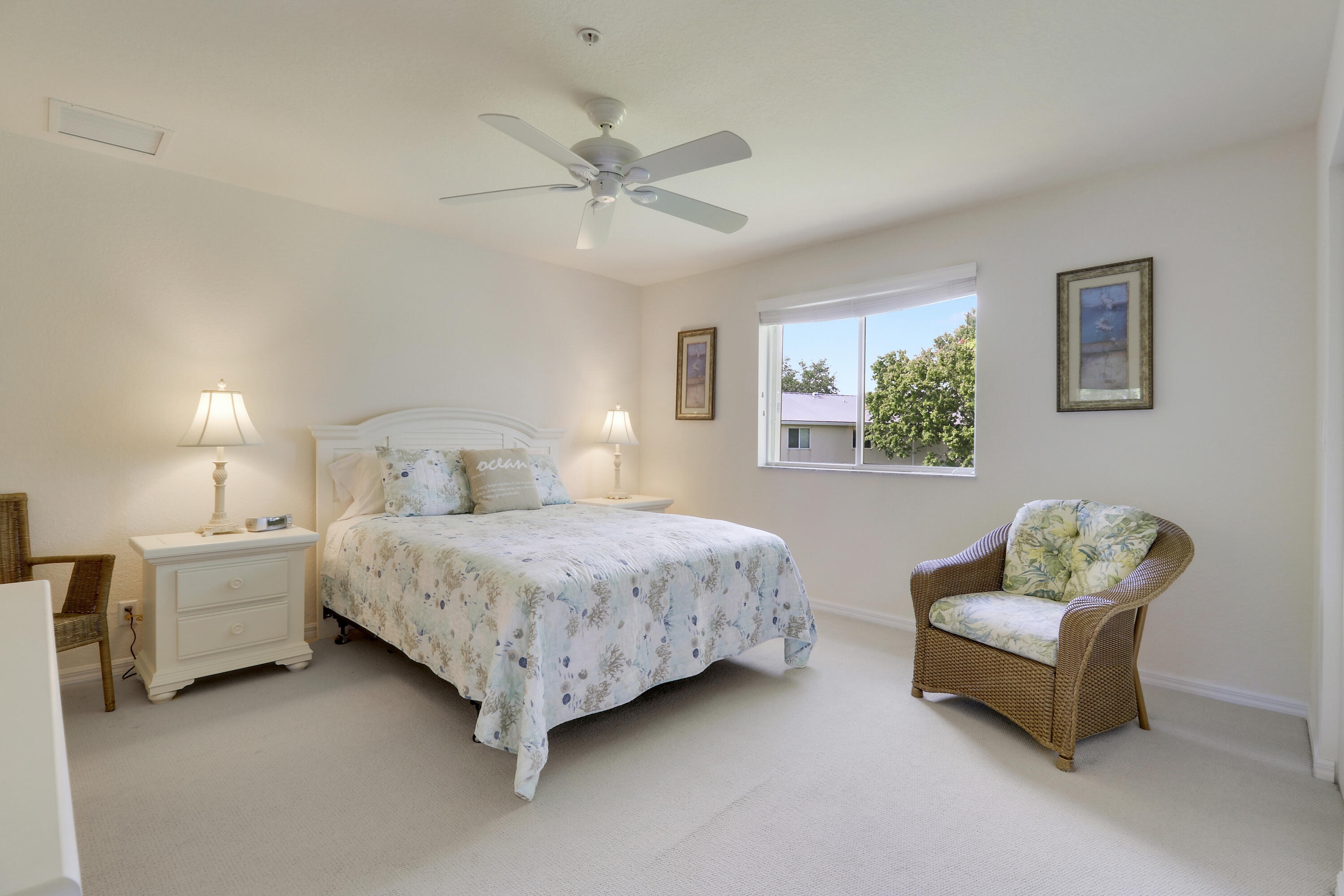 5410 Southeast Mitchell Lane Stuart, FL 34997 - Photo 17 of 24 a bedroom with a bed and a couch