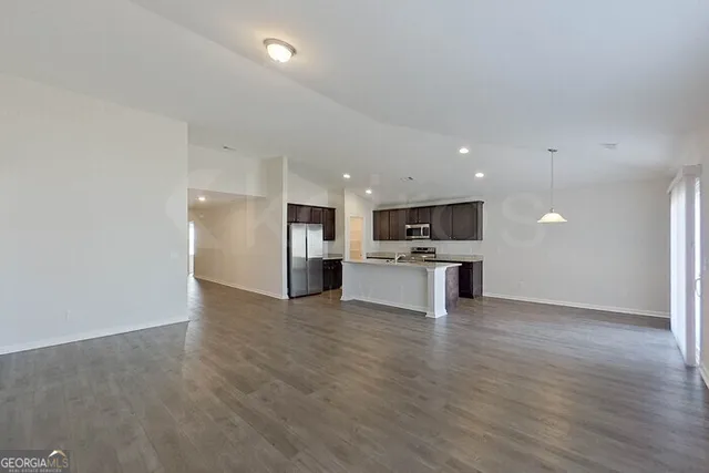 a view of kitchen with kitchen island and stainless steel appliances
