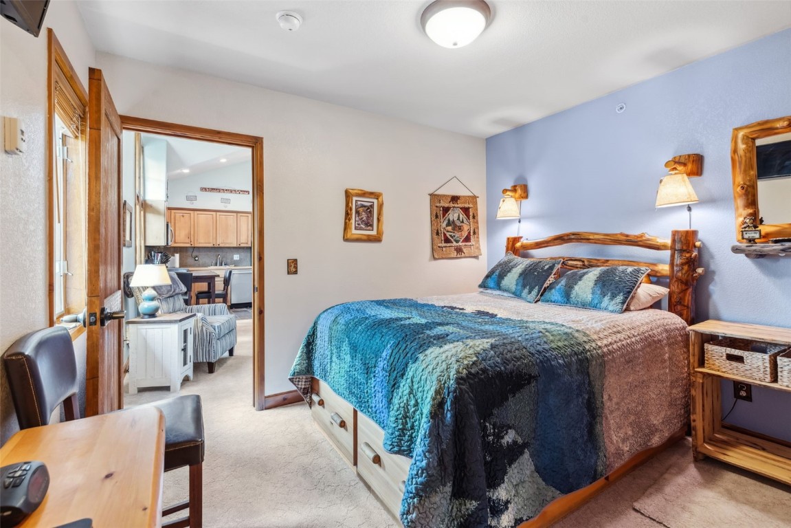 655 4 O Clock Road, Unit 301 Breckenridge, CO 80424 - Photo 12 of 23 a bedroom with a bed and wooden floor
