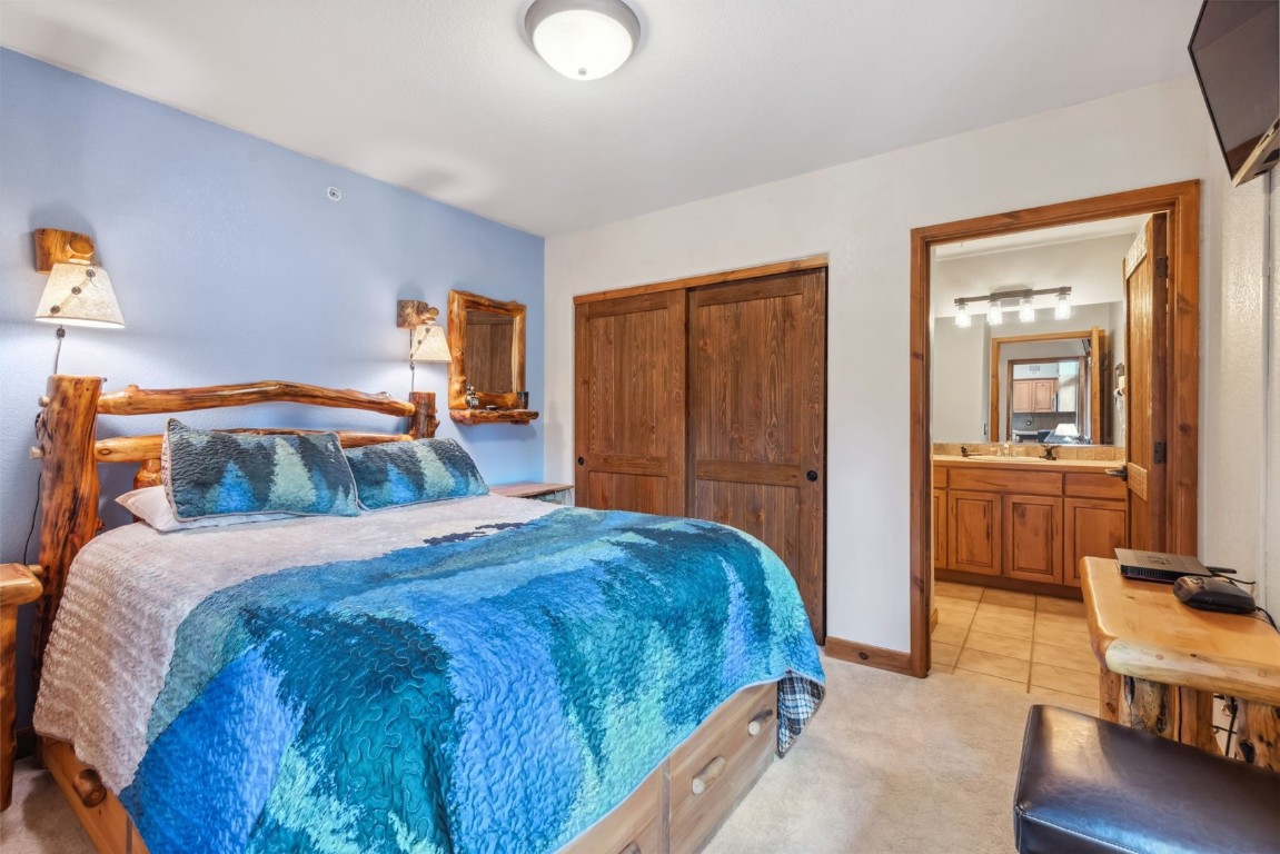 655 4 O Clock Road, Unit 301 Breckenridge, CO 80424 - Photo 4 of 23 a bedroom with a bed and a table