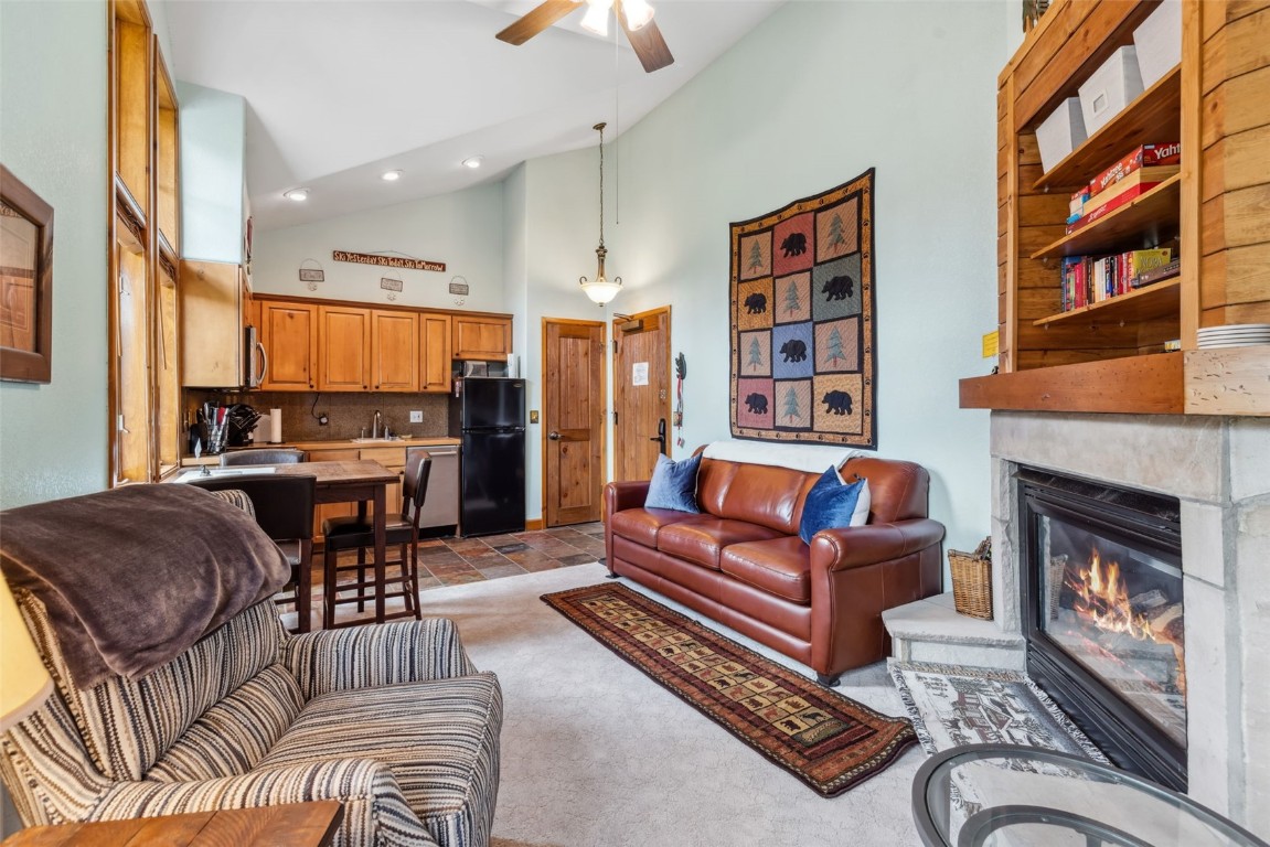 655 4 O Clock Road, Unit 301 Breckenridge, CO 80424 - Photo 6 of 23 a living room with furniture a fireplace and a chandelier