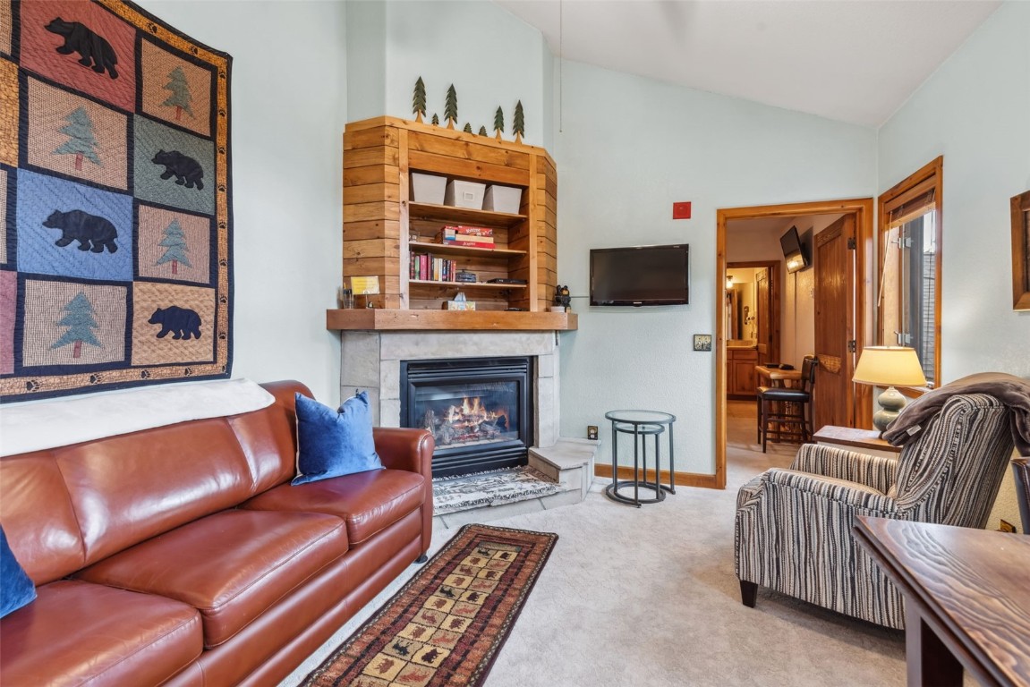 655 4 O Clock Road, Unit 301 Breckenridge, CO 80424 - Photo 7 of 23 a living room with furniture fireplace and flat screen tv