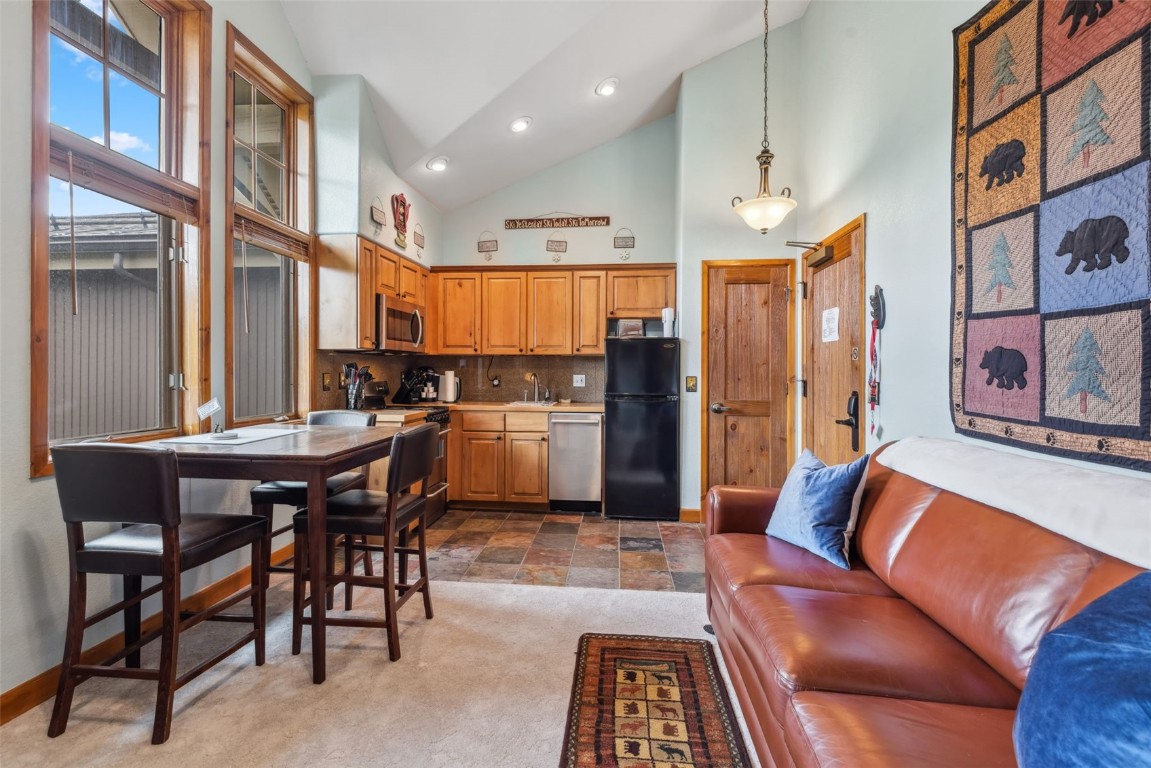655 4 O Clock Road, Unit 301 Breckenridge, CO 80424 - Photo 9 of 23 a living room with stainless steel appliances kitchen island granite countertop furniture and a large window