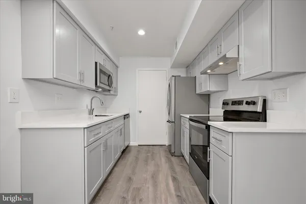 a kitchen with a sink dishwasher and microwave
