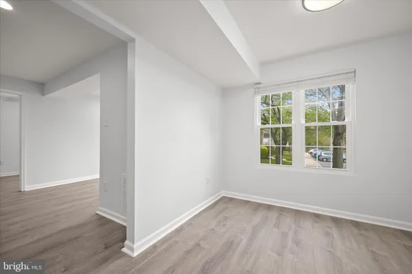 a view of an empty room with wooden floor