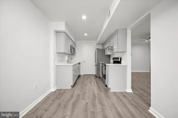 an empty room with a window and a ceiling fan