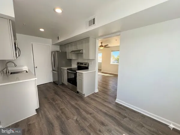 a kitchen with a refrigerator and a sink