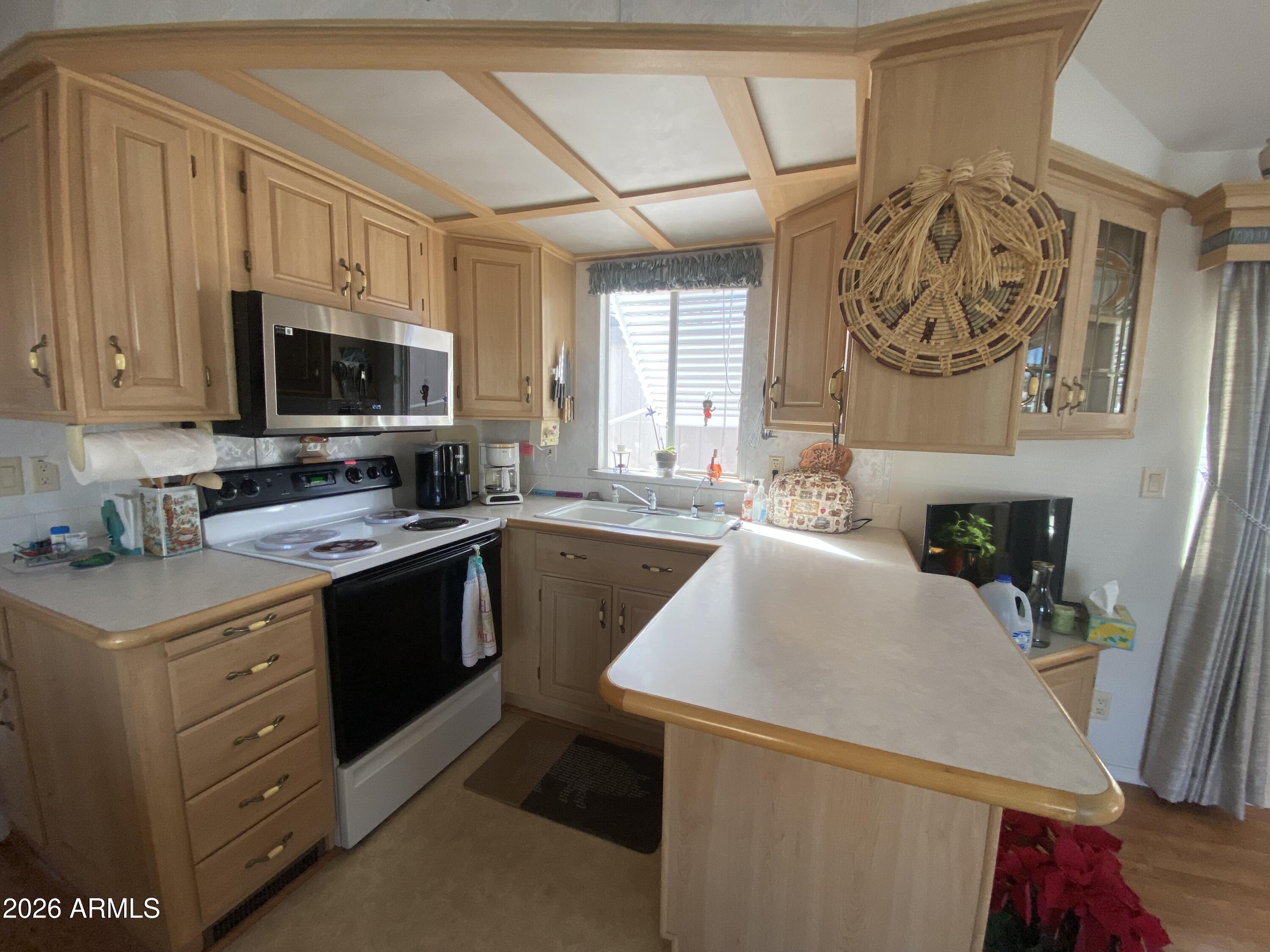 1336 West Inuit Avenue, Unit 336 Apache Junction, AZ 85119 - Photo 11 of 35 a kitchen with a sink and a stove top oven
