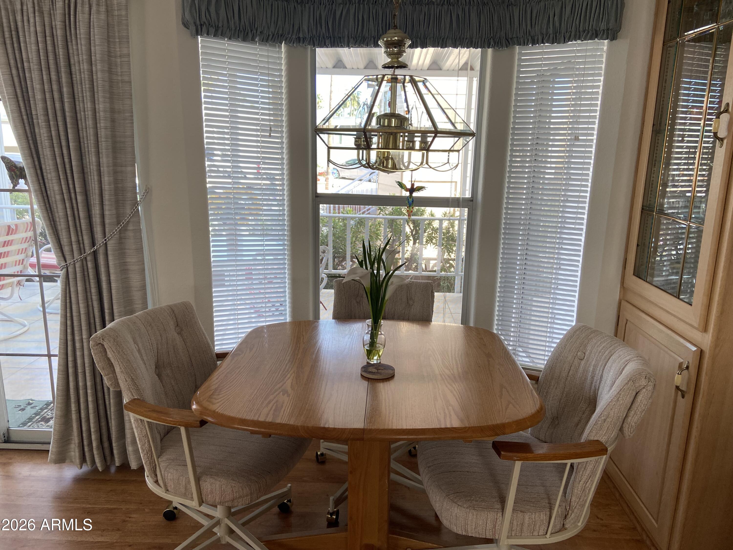 1336 West Inuit Avenue, Unit 336 Apache Junction, AZ 85119 - Photo 12 of 35 a view of a dining room with furniture and wooden floor