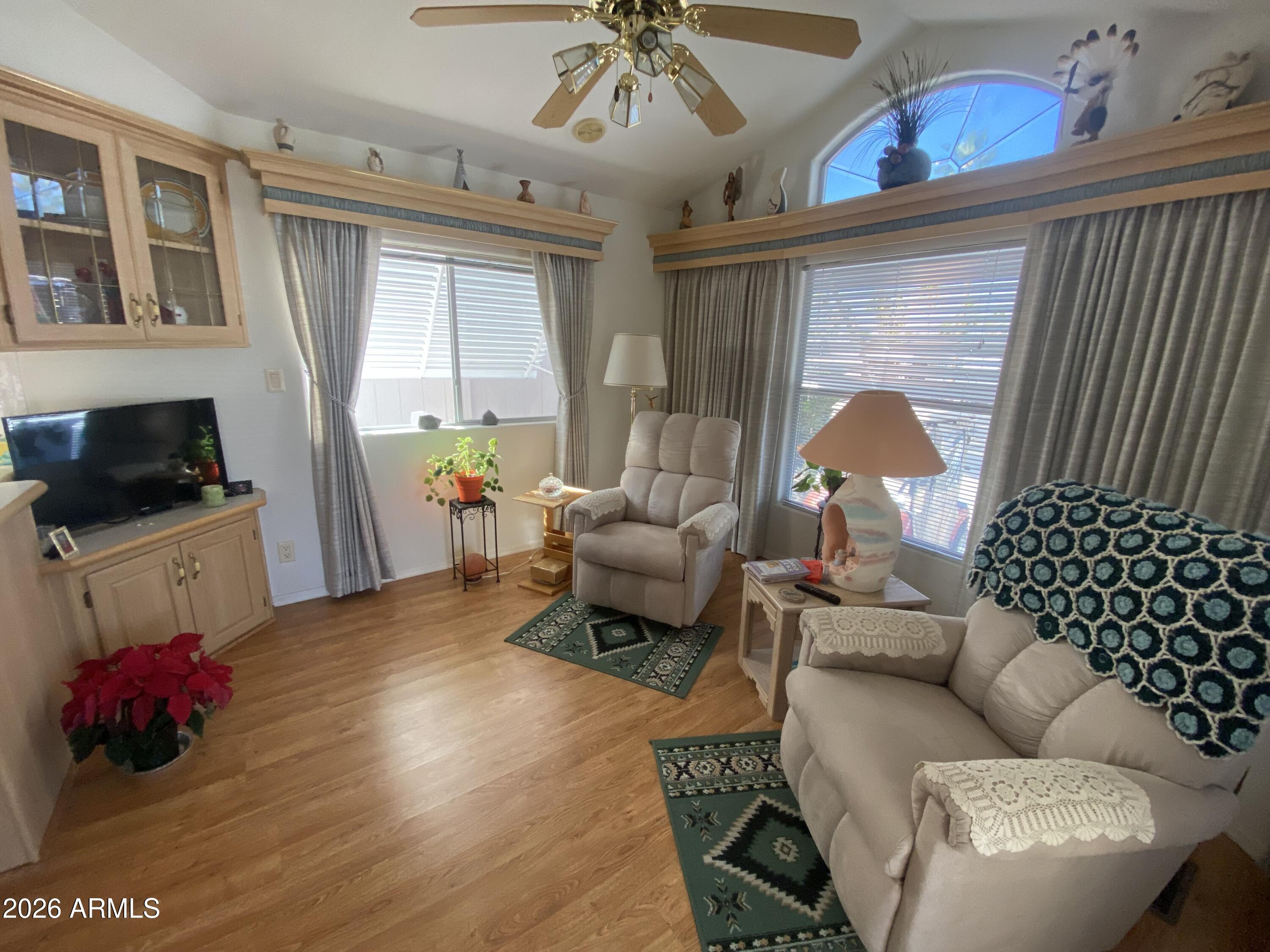1336 West Inuit Avenue, Unit 336 Apache Junction, AZ 85119 - Photo 14 of 35 a living room with furniture and a chandelier