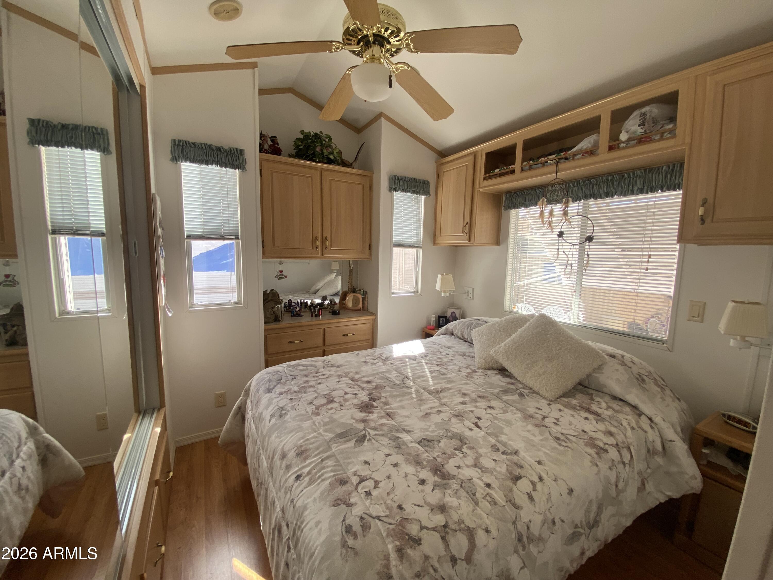 1336 West Inuit Avenue, Unit 336 Apache Junction, AZ 85119 - Photo 21 of 35 a bedroom with a bed dresser and a window