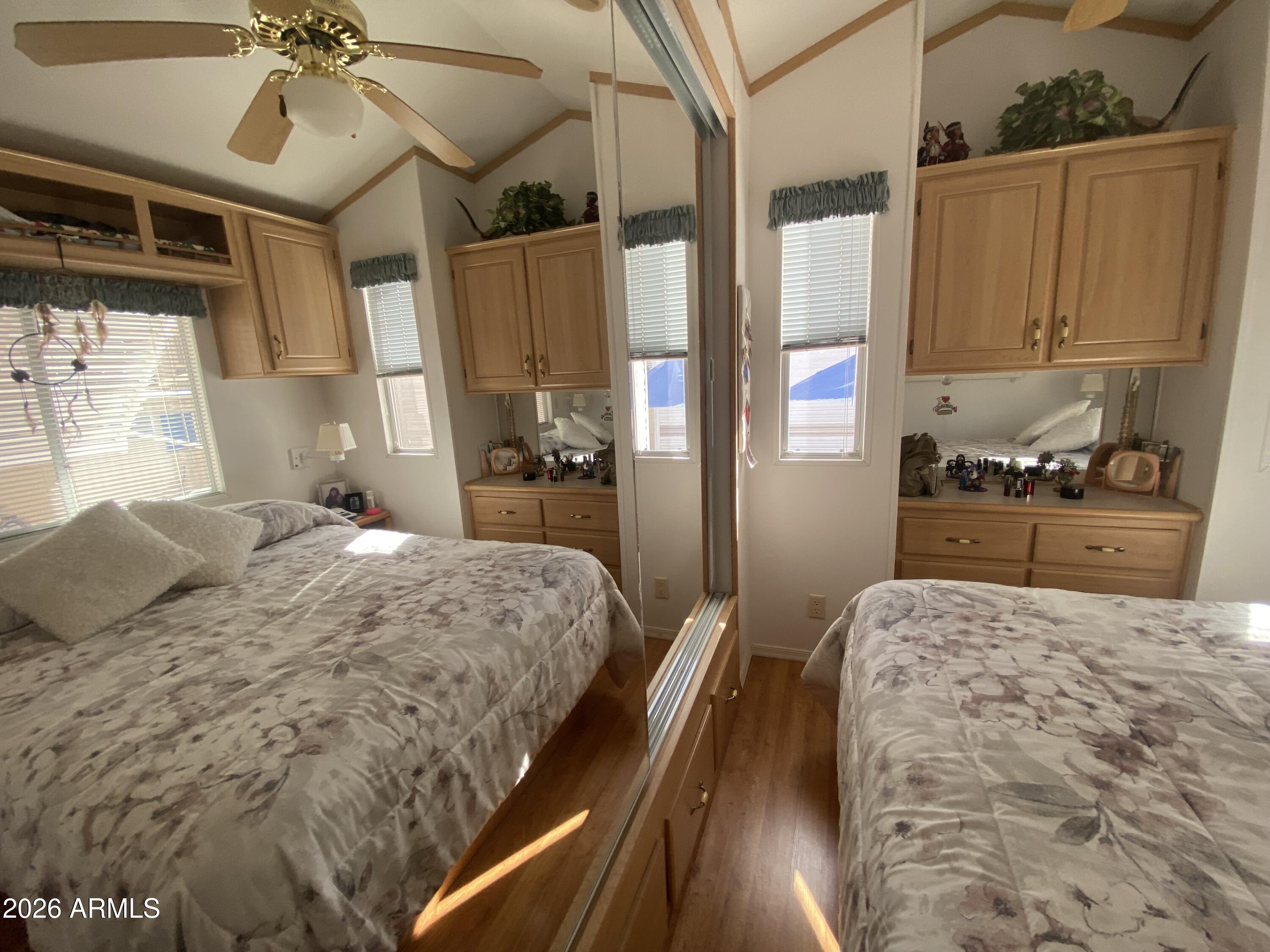 1336 West Inuit Avenue, Unit 336 Apache Junction, AZ 85119 - Photo 22 of 35 a bedroom with a bed and a chandelier