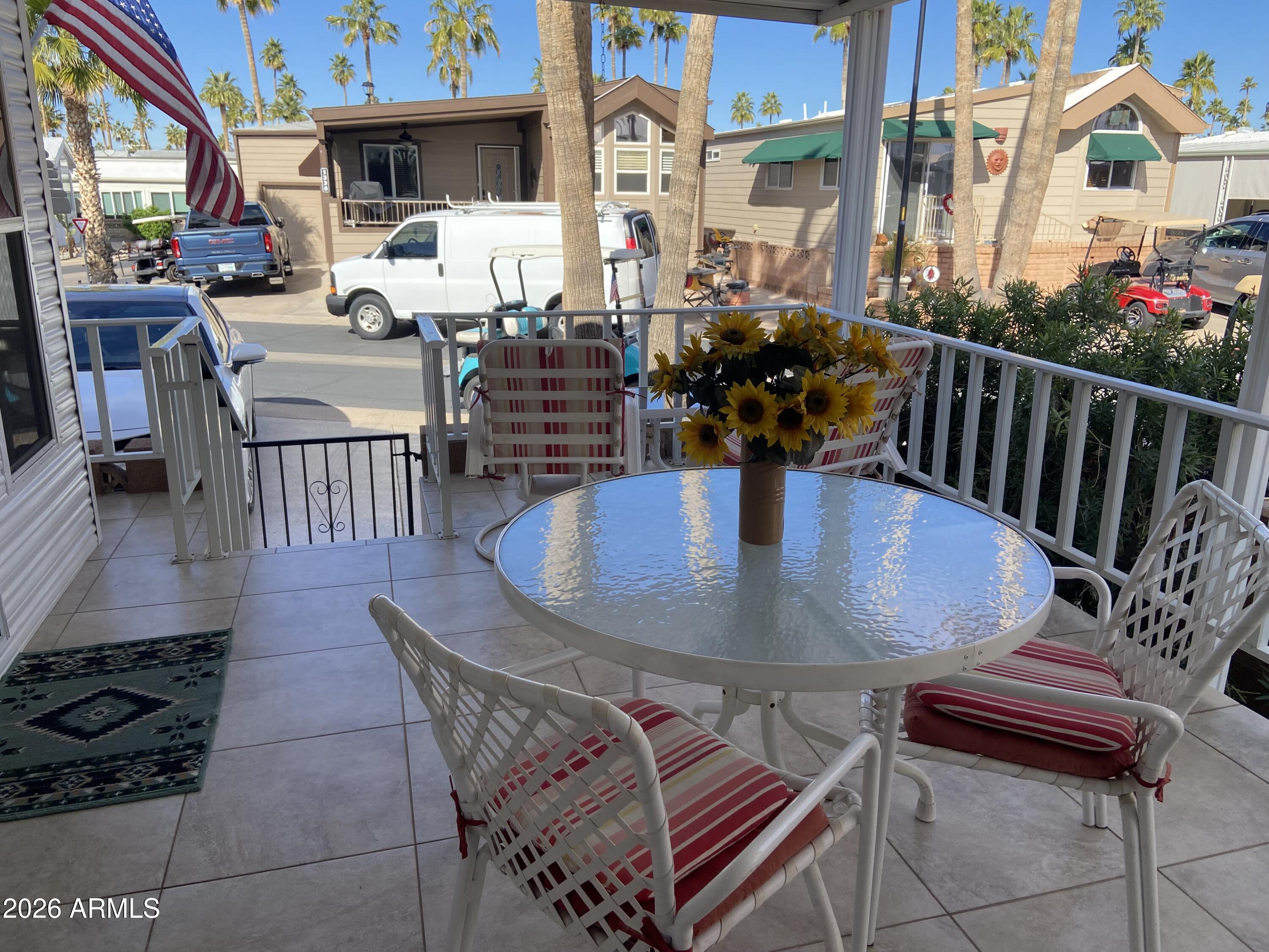 1336 West Inuit Avenue, Unit 336 Apache Junction, AZ 85119 - Photo 3 of 35 a view of a dining room with furniture and wooden floor