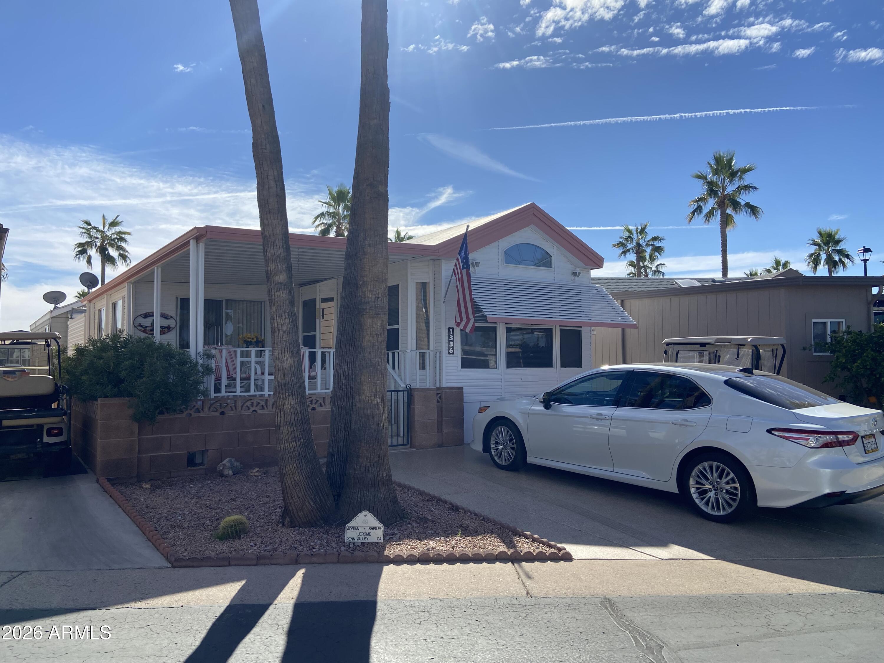 1336 West Inuit Avenue, Unit 336 Apache Junction, AZ 85119 - Photo 32 of 35 a car parked in front of a building