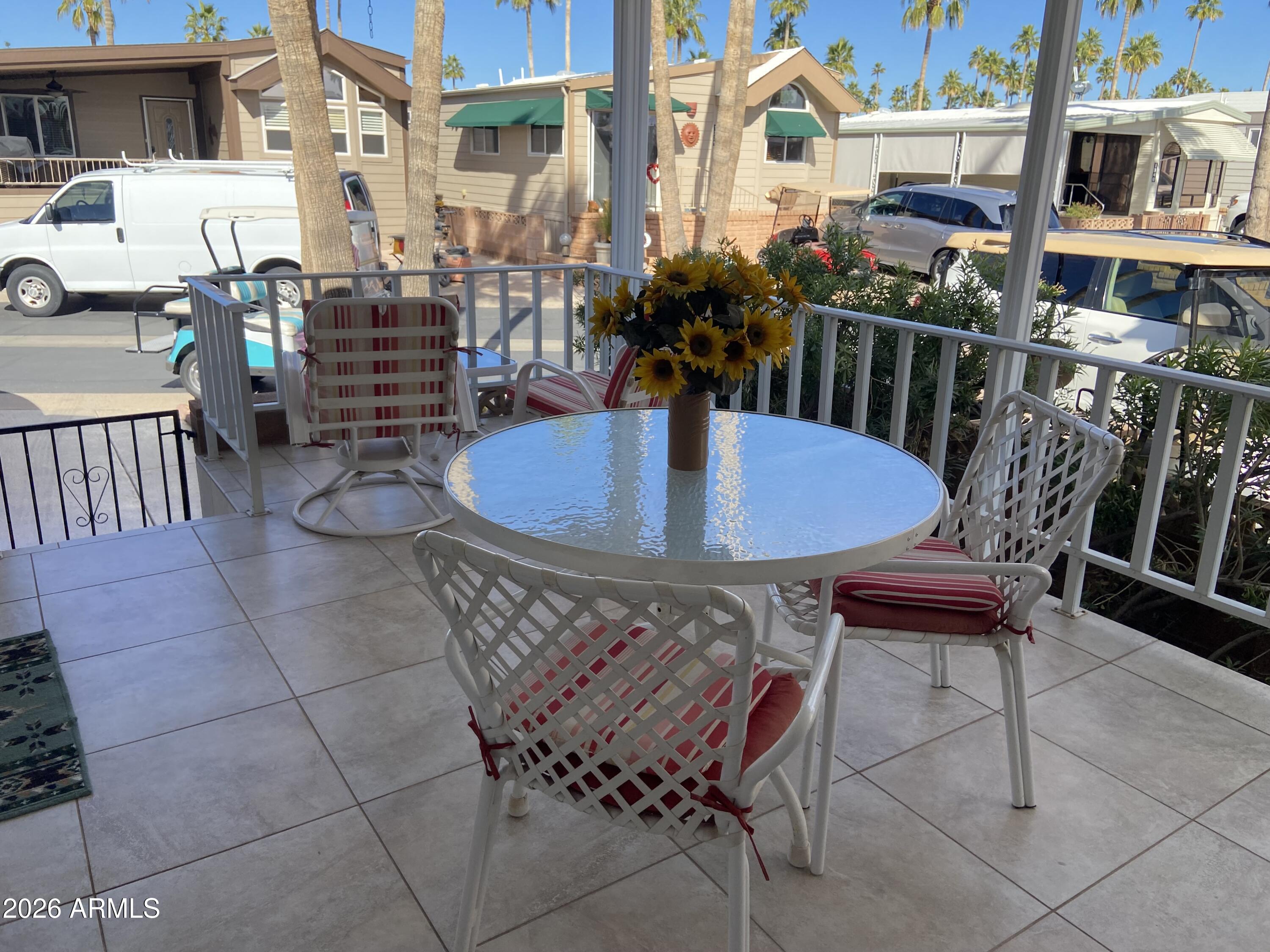 1336 West Inuit Avenue, Unit 336 Apache Junction, AZ 85119 - Photo 4 of 35 a view of a patio with swimming pool table and chairs