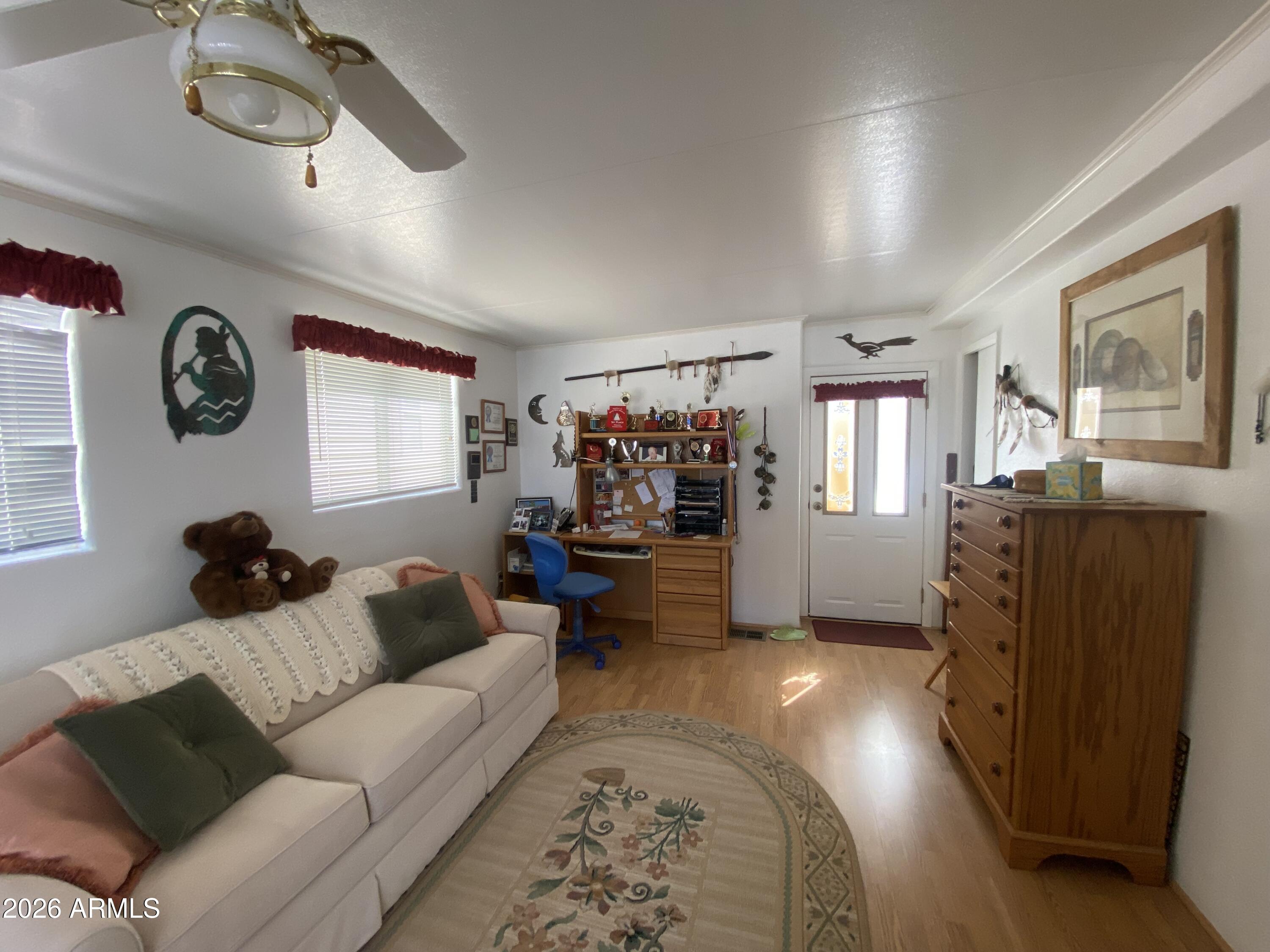 1336 West Inuit Avenue, Unit 336 Apache Junction, AZ 85119 - Photo 5 of 35 a living room with furniture and a window