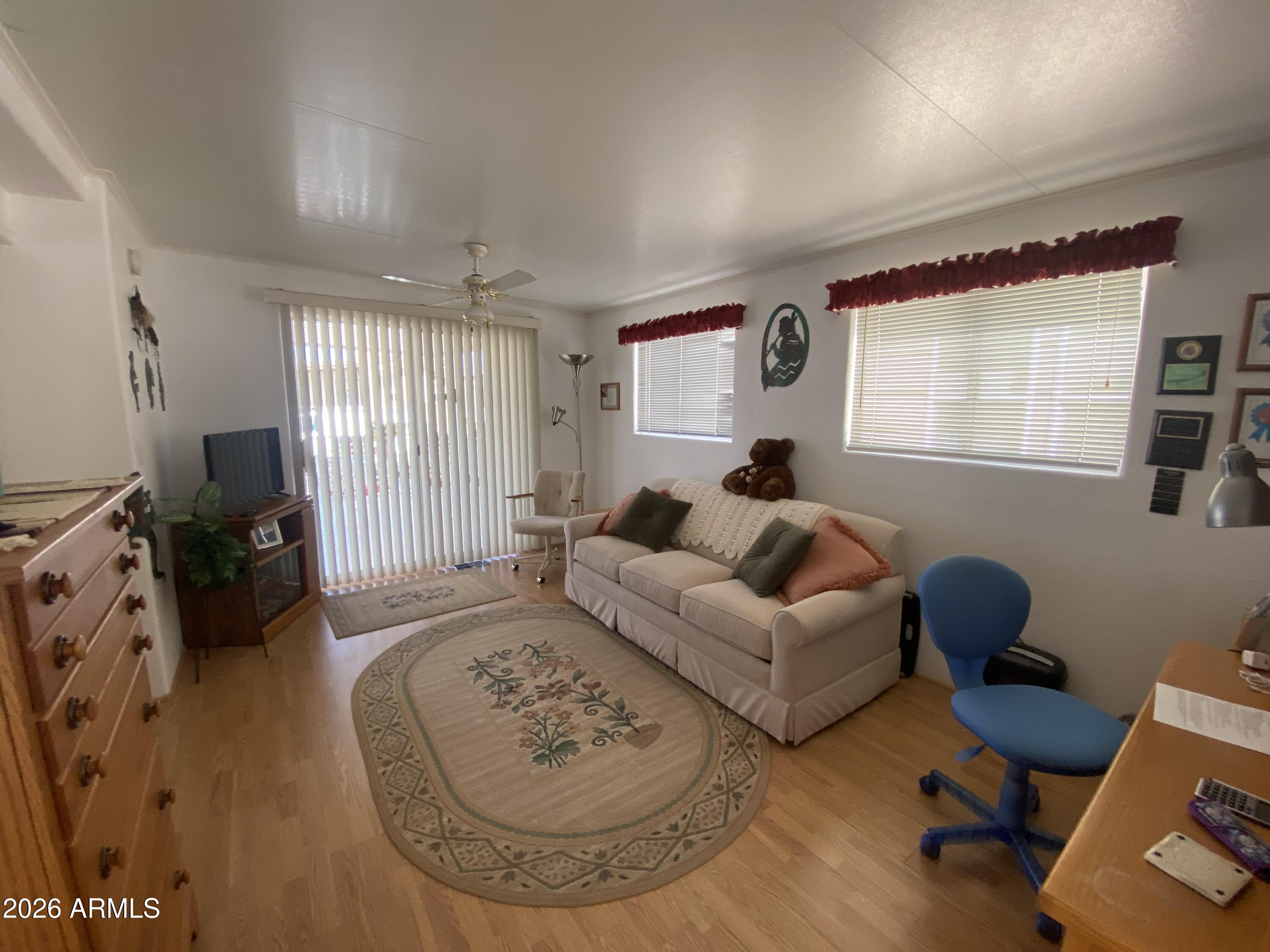 1336 West Inuit Avenue, Unit 336 Apache Junction, AZ 85119 - Photo 6 of 35 a living room with furniture and a flat screen tv