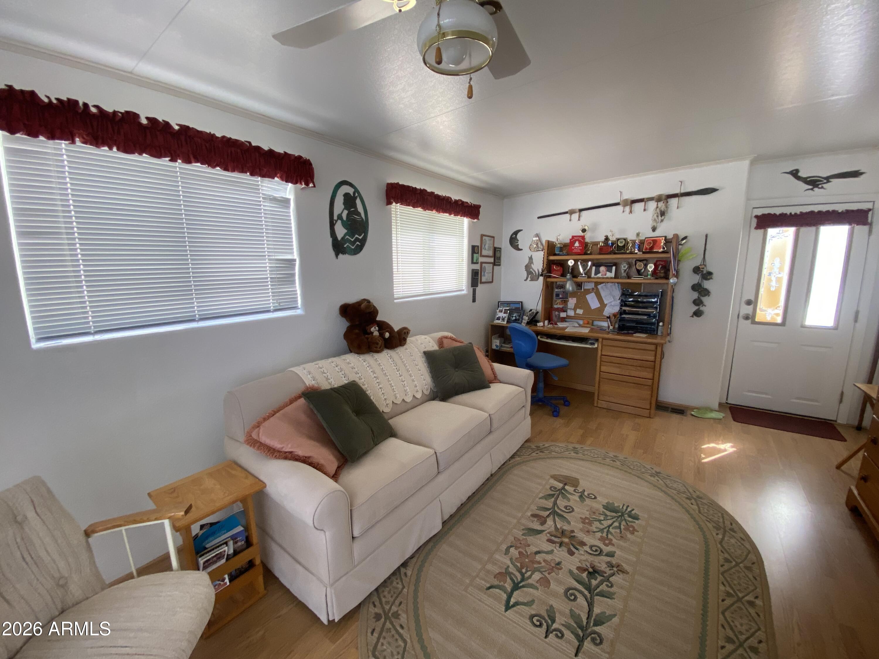 1336 West Inuit Avenue, Unit 336 Apache Junction, AZ 85119 - Photo 7 of 35 a living room with furniture and a flat screen tv