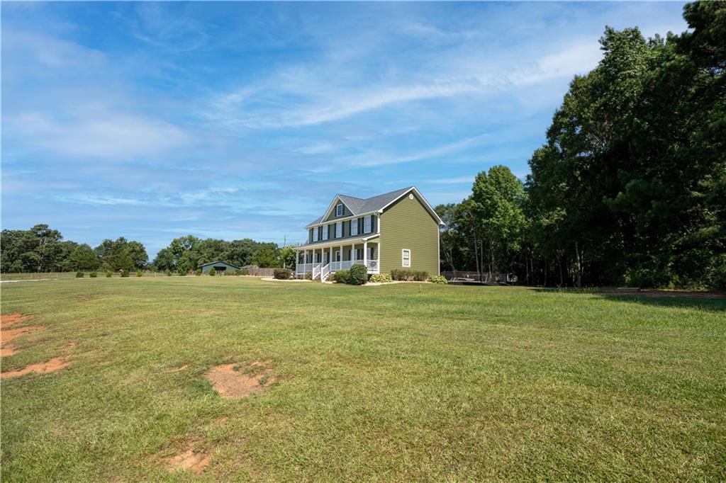 6858 Stone Bridge Road Carnesville, GA 30521 - Photo 1 of 1 a view of a big room with a garden