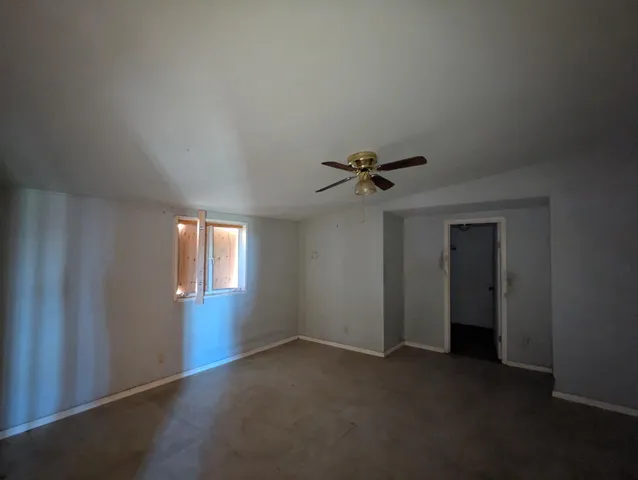 a view of a room with a empty space and windows