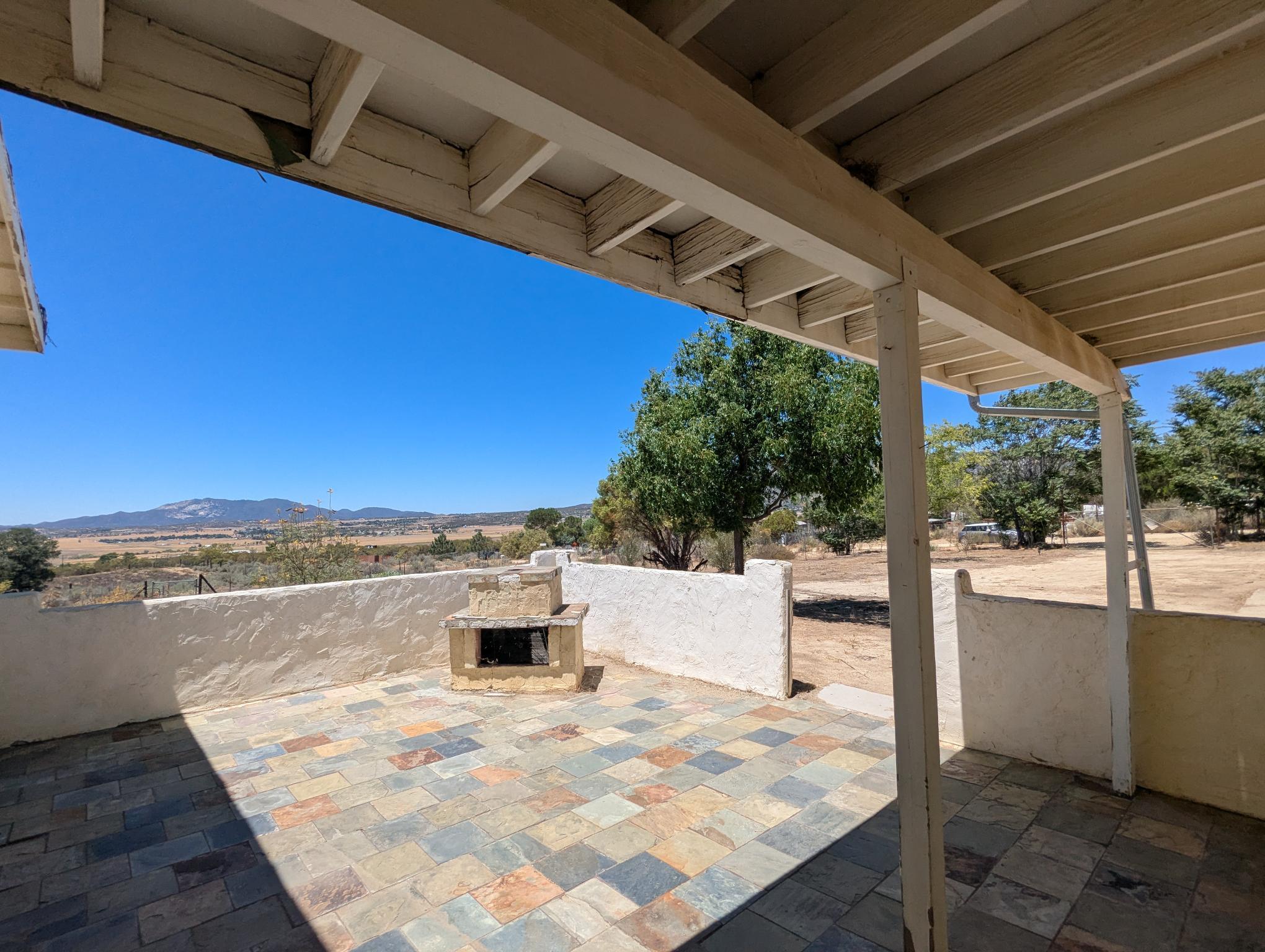 58841 Granite Gulley Road Anza, CA 92539 - Photo 5 of 18 a view of roof deck with a barbeque and wooden stairs