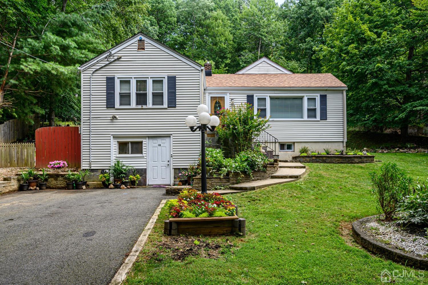 10 Stiles Road Warren, NJ 07059 - Photo 1 of 39 a front view of a house with a yard and garage