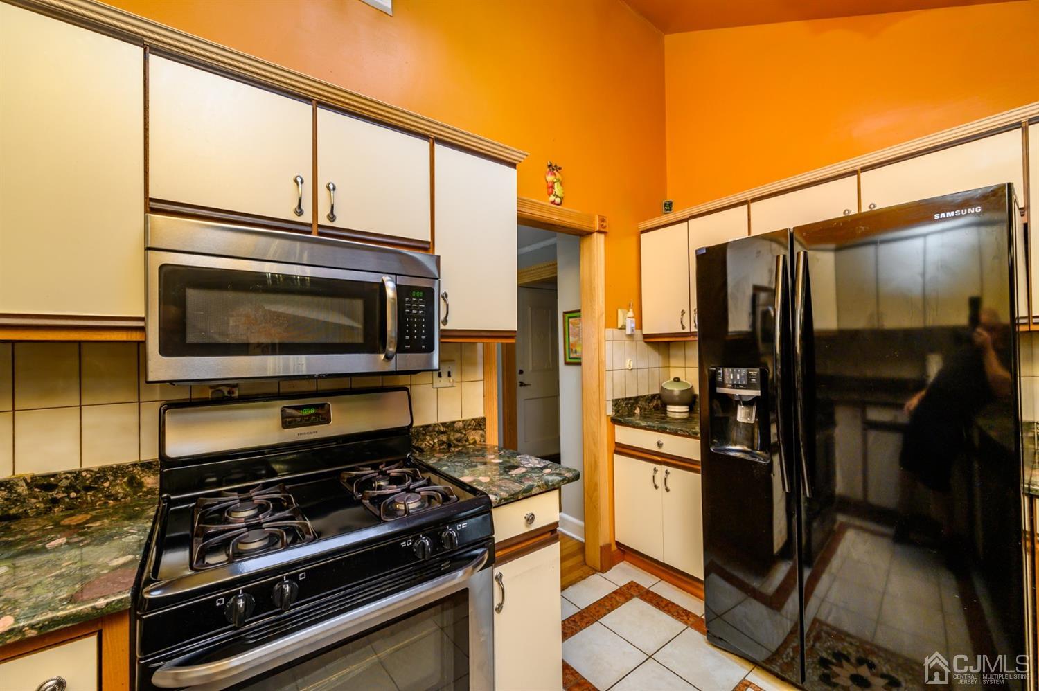 10 Stiles Road Warren, NJ 07059 - Photo 18 of 39 a kitchen with stainless steel appliances a stove and a refrigerator