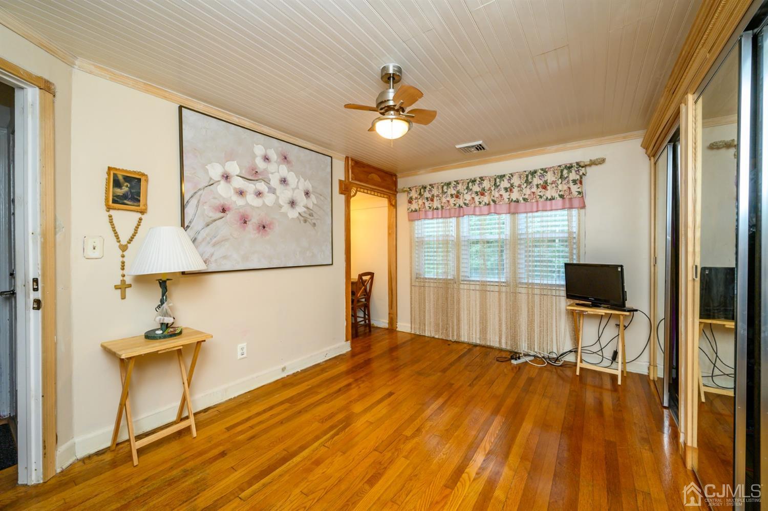 10 Stiles Road Warren, NJ 07059 - Photo 21 of 39 a view of a livingroom with wooden floor and a ceiling fan