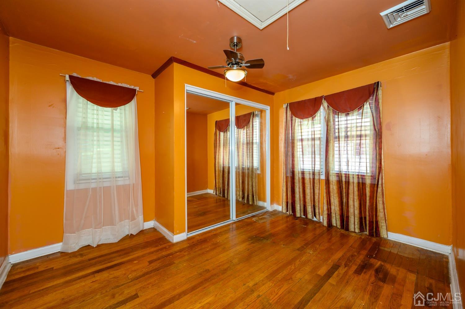 10 Stiles Road Warren, NJ 07059 - Photo 23 of 39 an empty room with wooden floor and windows