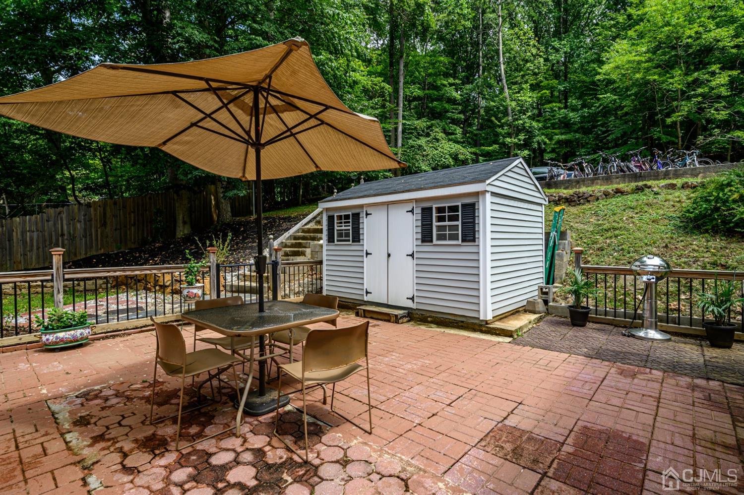 10 Stiles Road Warren, NJ 07059 - Photo 33 of 39 a backyard of a house with barbeque oven table and chairs