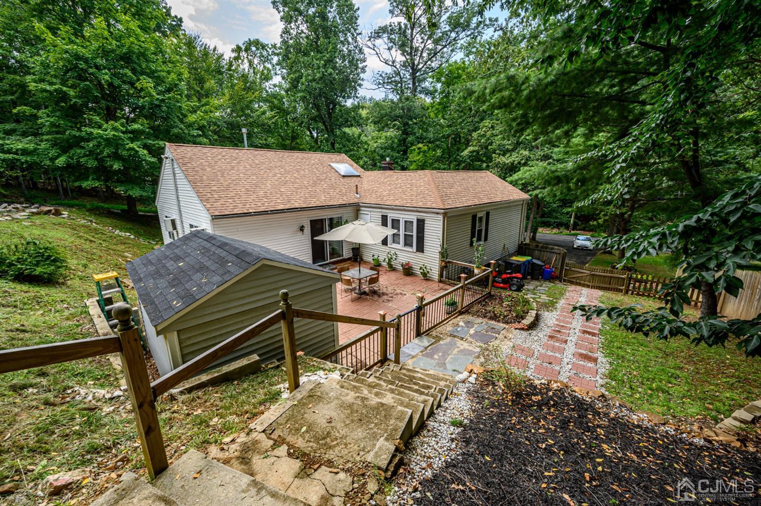 10 Stiles Road Warren, NJ 07059 - Photo 35 of 39 a view of a patio with a table chairs and a small yard