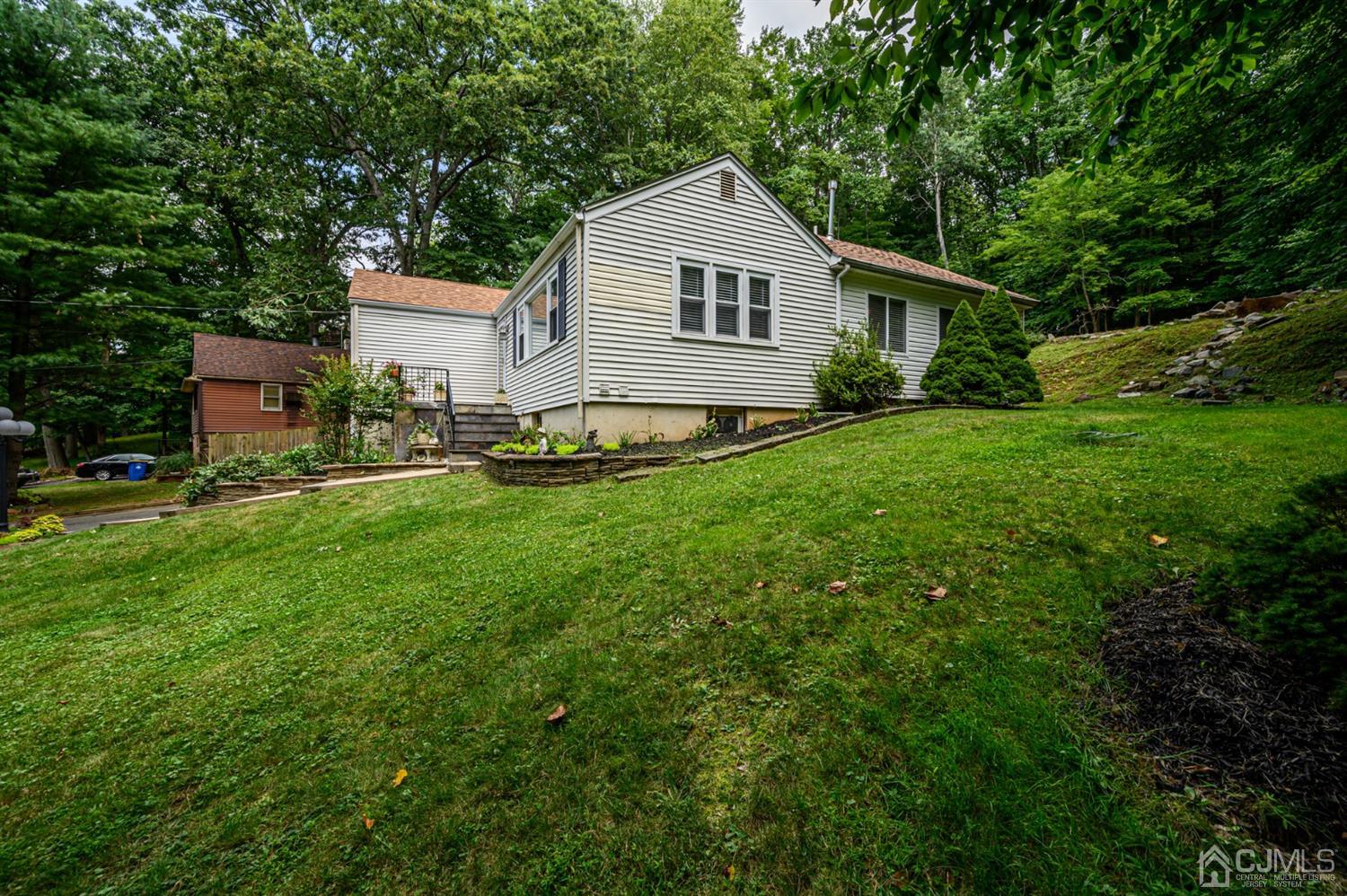 10 Stiles Road Warren, NJ 07059 - Photo 36 of 39 a front view of house with yard and green space